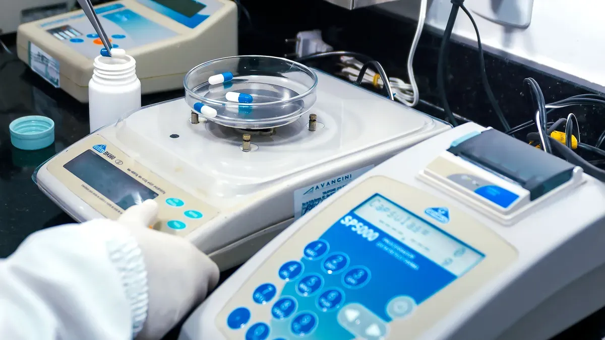 Water testing laboratory with precision analytical equipment, petri dishes containing samples, and digital analysis instruments for water quality assessment.